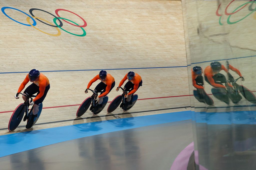 Netherlands' Roy van den Berg, Netherlands' Harrie Lavreysen and Netherlands' Jeffrey Hoogland compete in the men's track cycling team sprint first round of the Paris 2024 Olympic Games at the Saint-Quentin-en-Yvelines National Velodrome in Montigny-le-Bretonneux, south-west of Paris, on August 6, 2024. (Photo by Thomas SAMSON / AFP)