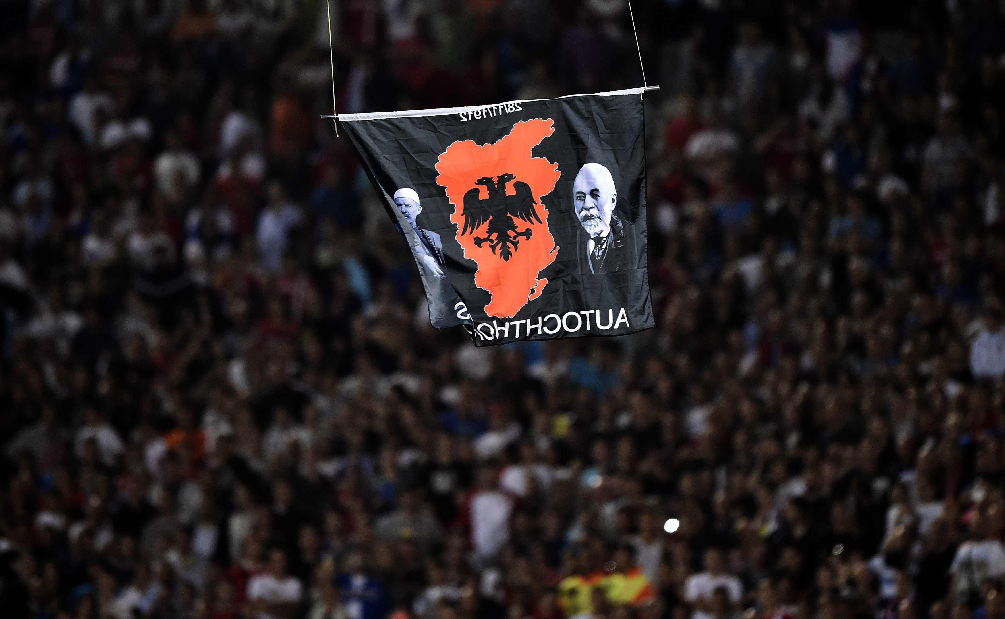 A flag with Albanian national symbols attached to a remotely operated drone flies in the stadium during the EURO 2016 group I football match between Serbia and Albania in Belgrade on October 14, 2014. AFP PHOTO / ANDREJ ISAKOVIC (Photo credit should read ANDREJ ISAKOVIC/AFP via Getty Images)