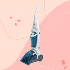 Russell Hobbs Upgright Carpet Cleaner on a pink background