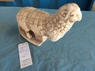 Ancient artisans meticulously carved the marble ram's curled horns.