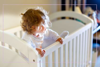 When to put a toddler in a bed illustrated by toddler climbing out of the cot