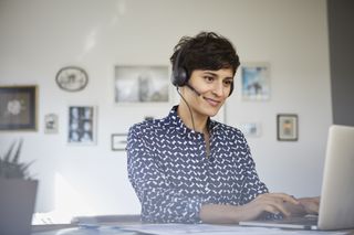 Smiling woman working from home as a translator