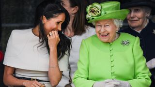 Queen Elizabeth II sits and laughs with Meghan, Duchess of Sussex during a ceremony to open the new Mersey Gateway Bridge on June 14, 2018
