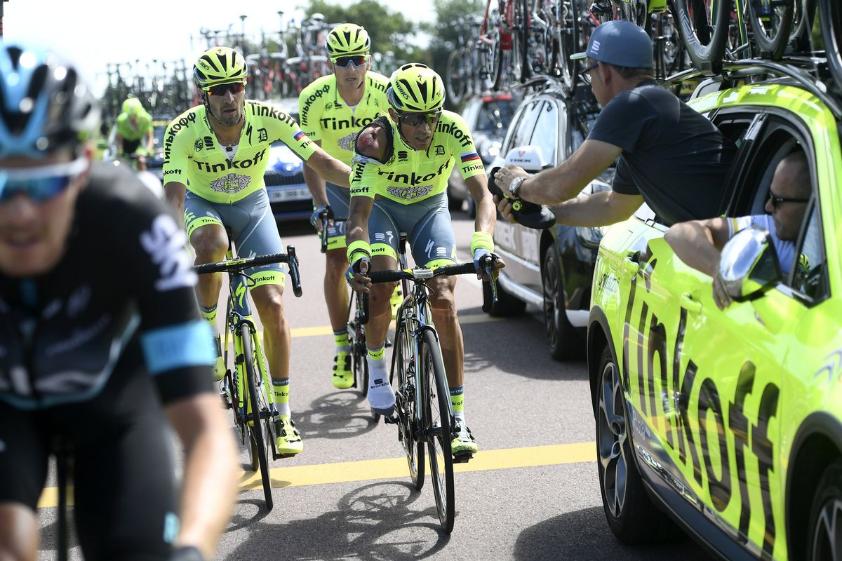 Alberto Contador is helped by Tinkoff teammates after his crash