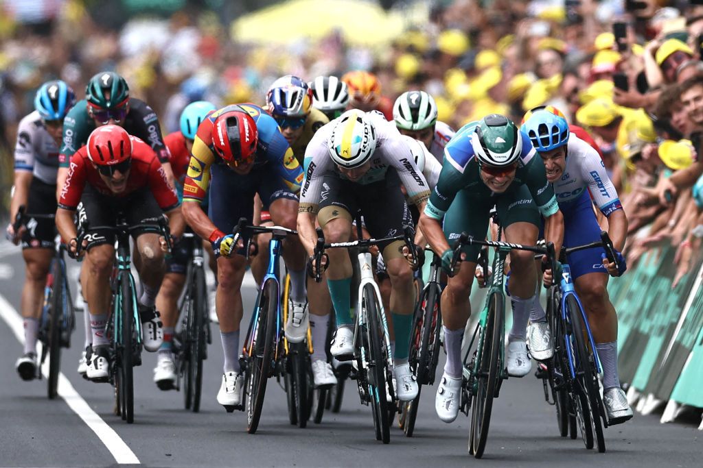 Alpecin-Deceuninck's Belgian rider Jasper Philipsen (2nd R) sprints to the finish line ahead of Team Jayco Alula's Dutch rider Dylan Groenewegen (R) and Bahrain - Victorious' German rider Phil Bauhaus (C) to win the 11th stage of the 110th edition of the Tour de France cycling race, 180 km between Clermont-Ferrand and Moulins, in central France, on July 12, 2023. (Photo by Anne-Christine POUJOULAT / AFP)