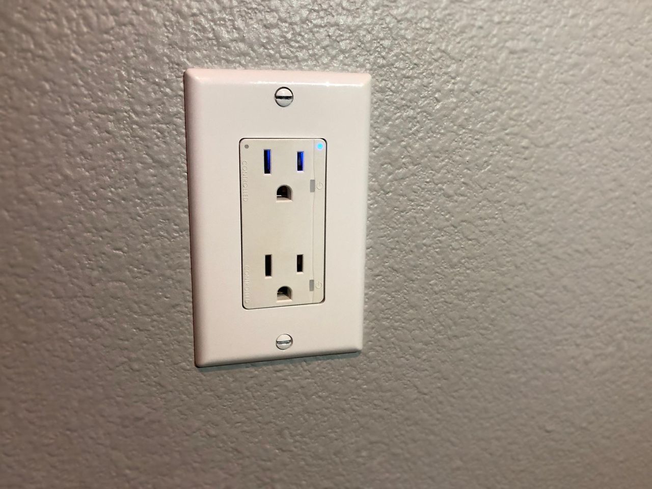 Connectsense Smart Inwall Outlet on a gray wall