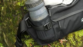 Close up of bottle in mesh side panel of Rapha Trail Hip pack