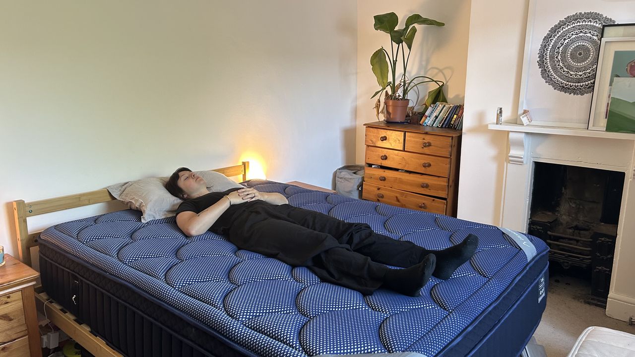 Our mattress tester assessing the comfort and support of the DreamCloud Luxe Memory Foam mattress by lying on her back