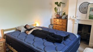 Our mattress tester assessing the comfort and support of the DreamCloud Luxe Memory Foam mattress by lying on her back
