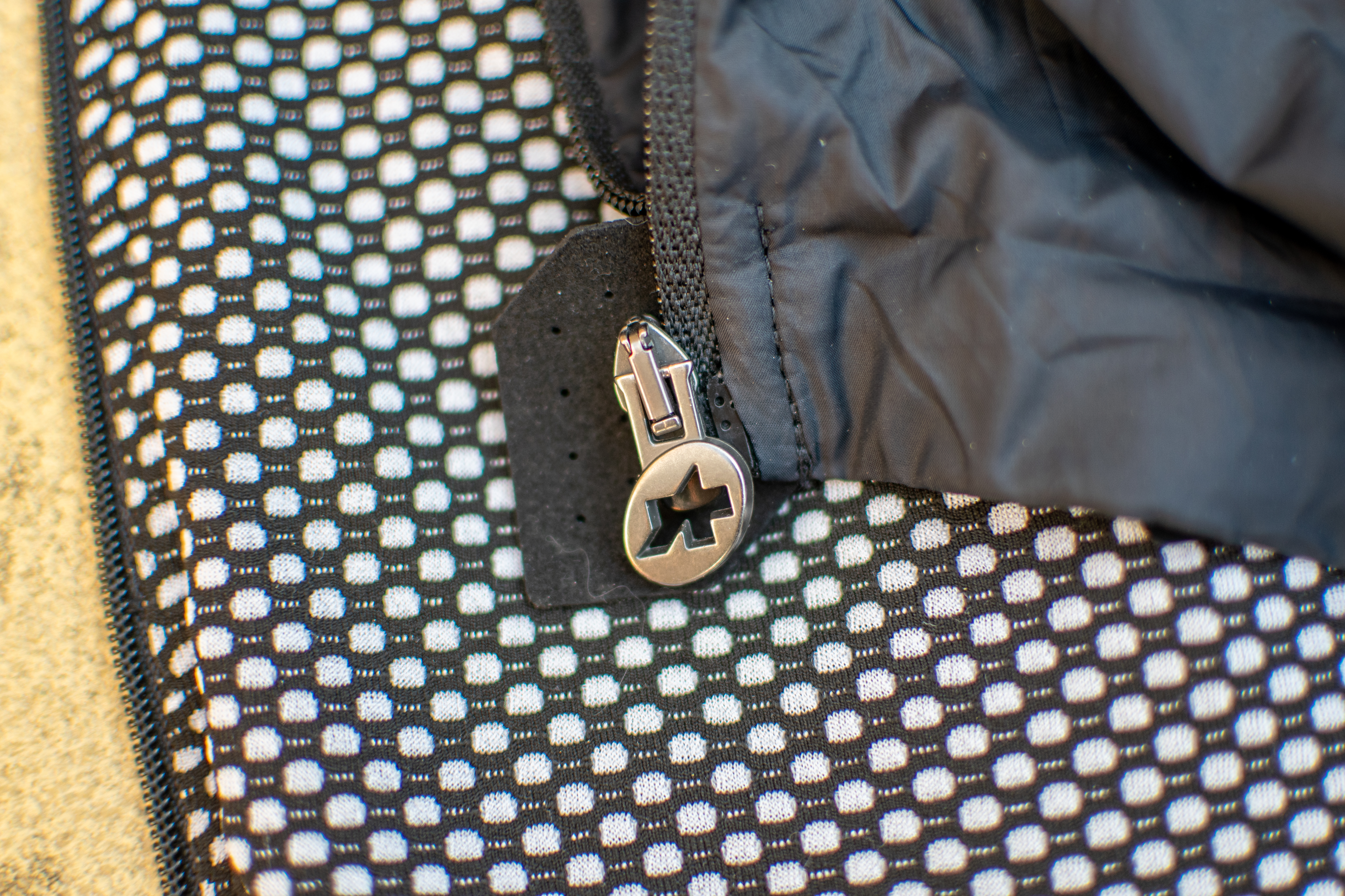 A black Assos Tactica T5 vest on some paving slabs