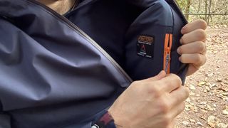 Opening the Passenger Eclipse Insulated Waterproof Jacket's interior pocket