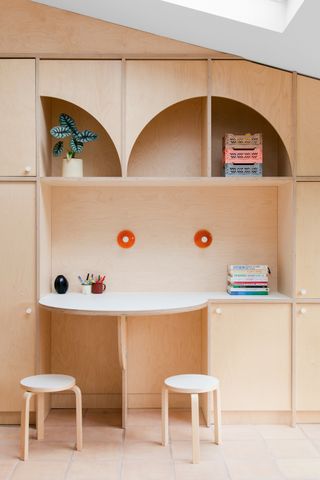 a desk made from plywood with semi circle cutouts