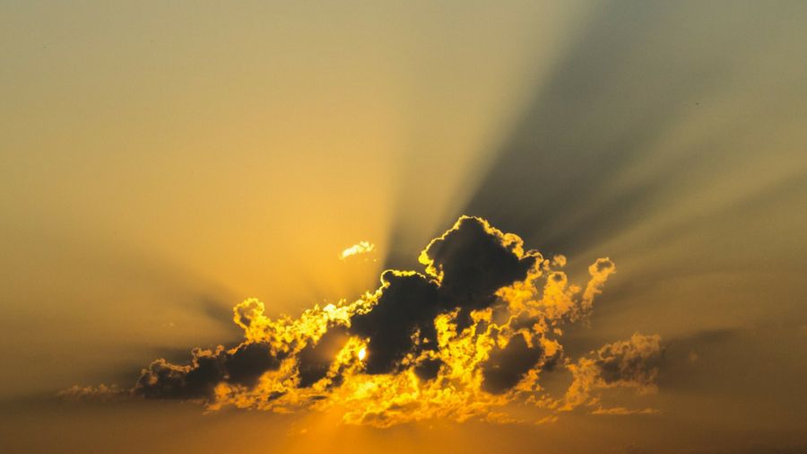 photo of rays of sun breaking through clouds