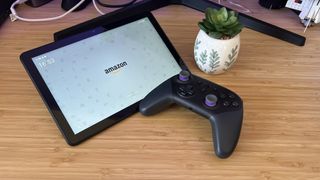 Amazon Fire HD 10 tablet with Luna controller and a plant on a wooden desk