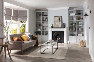 a living room with fireplace alcove storage