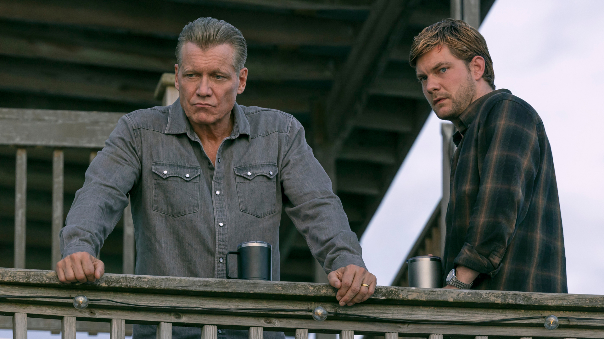 holt mccallany and jake creary as the buckley men standing on a balcony in the waterfront