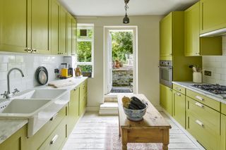 green kitchen in colourful London apartment