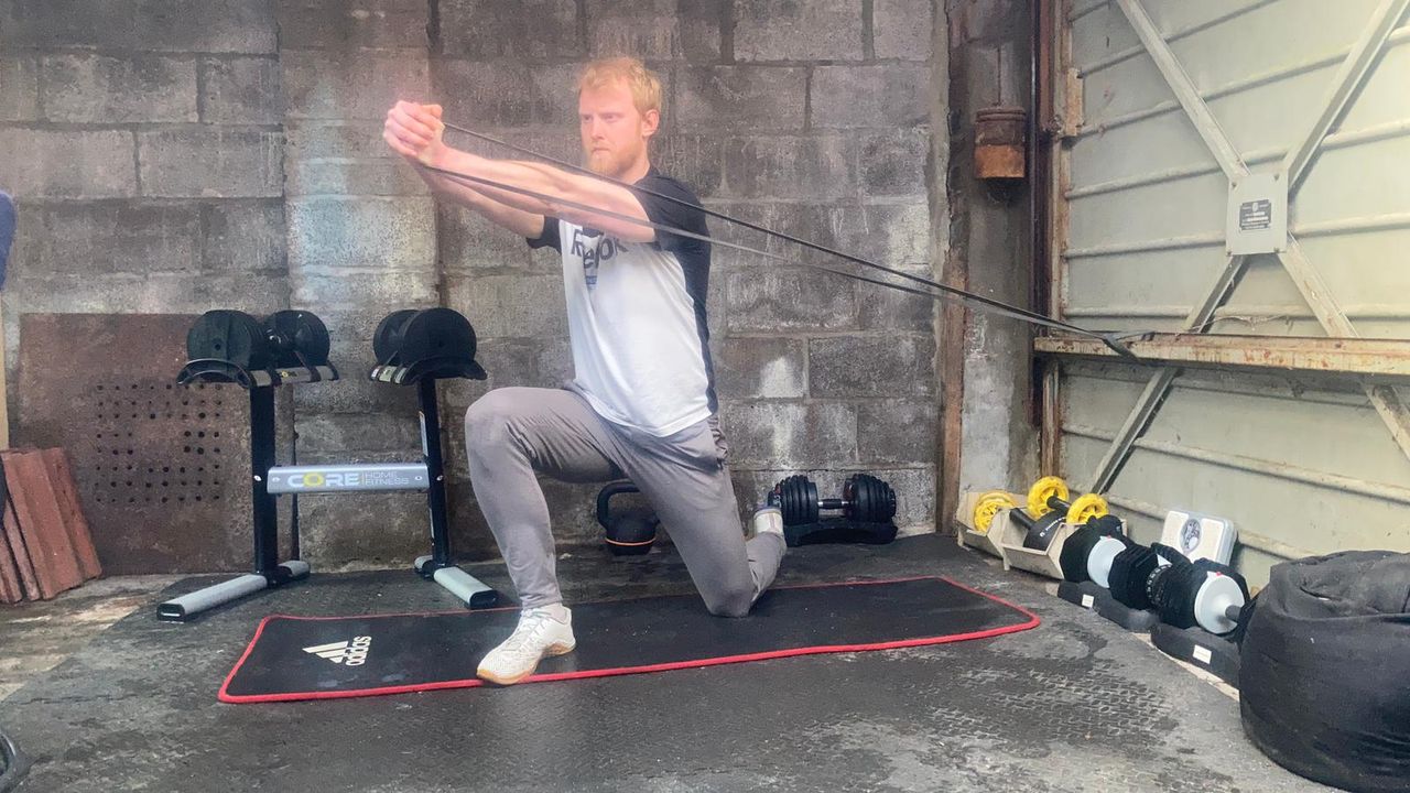 Fitness writer Harry Bullmore performing core exercises with a resistance band