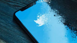 The Twitter logo on an iPhone after the Thanos snap