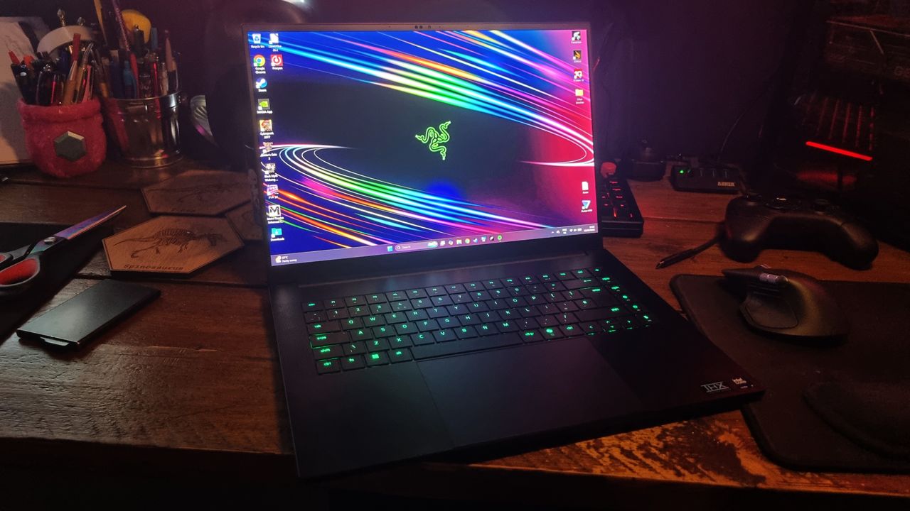 A Razer Blade 16 gaming laptop on a wooden desk