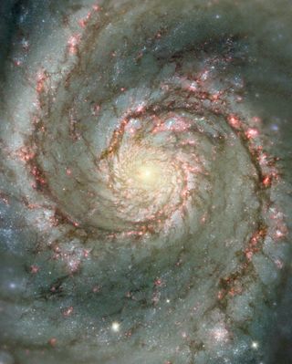 The Whirlpool Galaxy is a classic spiral galaxy. At only 30 million light years distant and fully 60 thousand light years across, M51, also known as NGC 5194, is one of the brightest and most picturesque galaxies on the sky. This image is a digital combination of a ground-based image from the 0.9-meter telescope at Kitt Peak National Observatory and a space-based image from the Hubble Space Telescope highlighting sharp features normally too red to be seen.