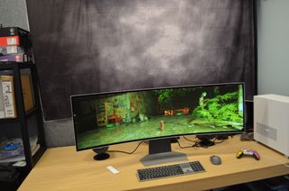 Samsung Odyssey OLED G9 on a desk displaying a game