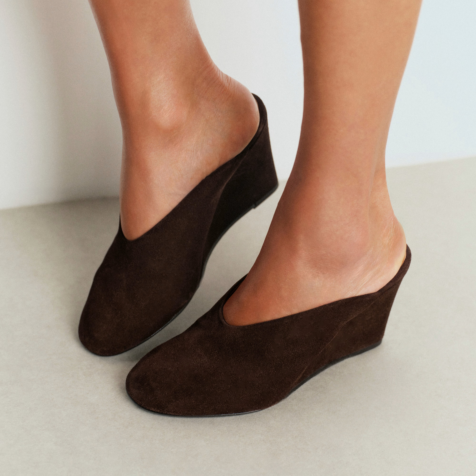An image of brown suede wedge mules