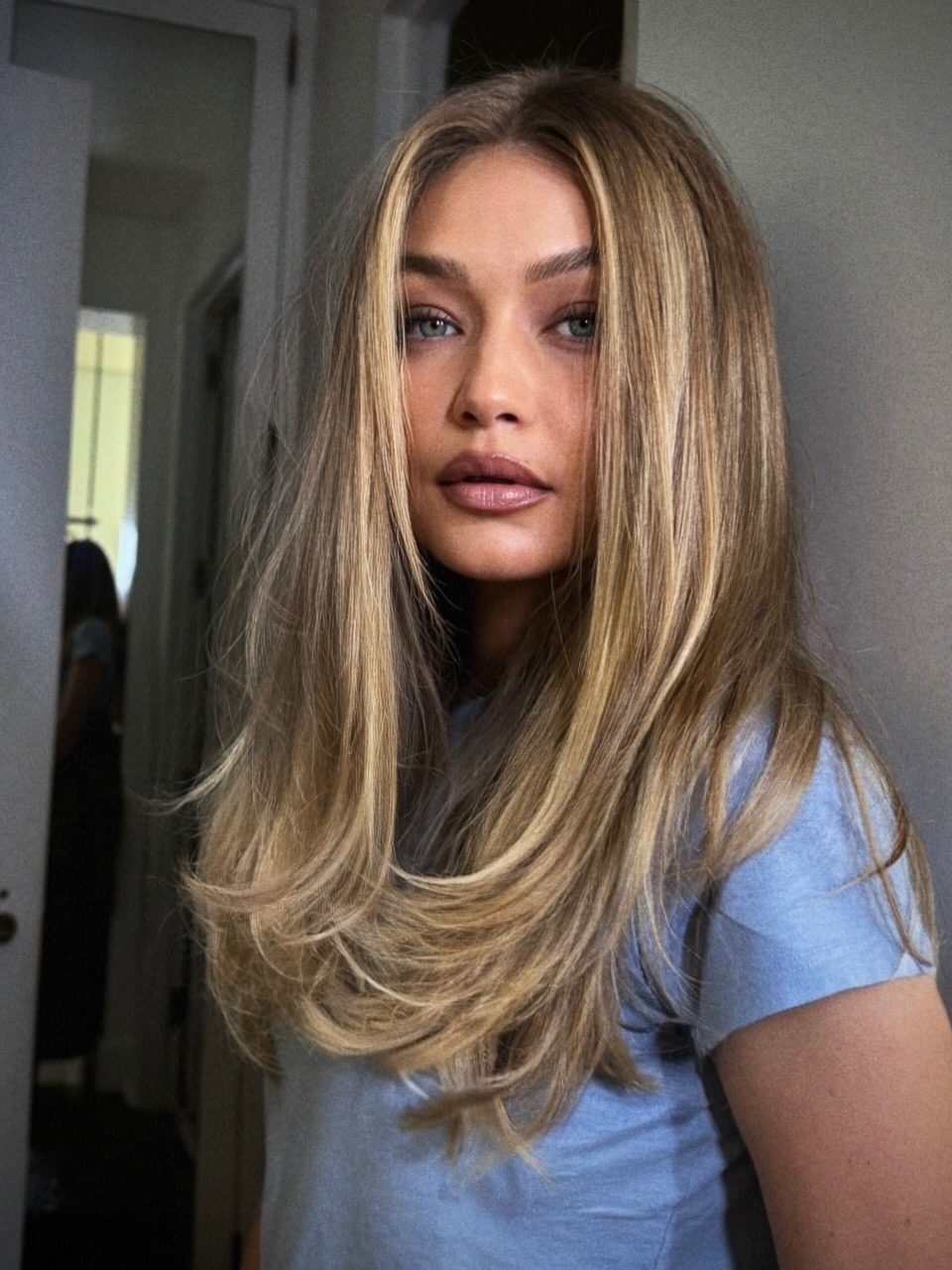 Gigi Hadid with a dimensional blonde hair colour and layered hairstyle