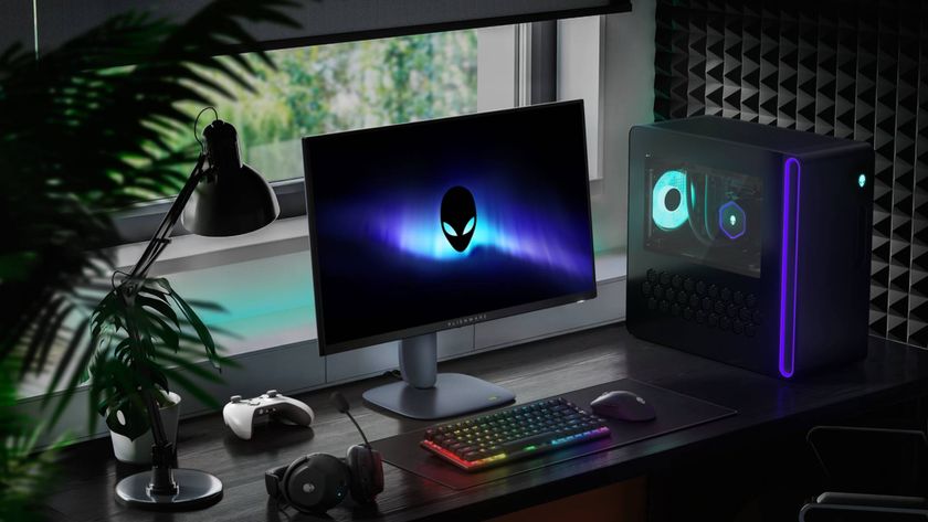 Alienware AW2725DM monitor sitting on desk next to Aurora R16, RGB keyboard, headset, and plants