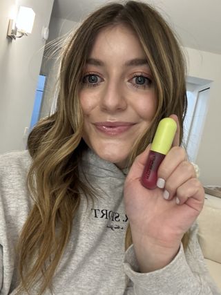 Beauty editor Samantha Holender wears the Wyn Beauty lip serum and skin tint with a sweatshirt