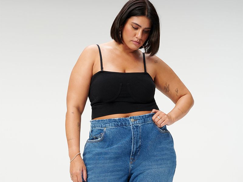 Model wears black tank and good american 90s relaxed jeans