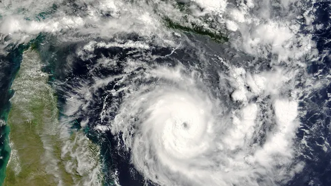 A satellite photo of clouds over land and ocean