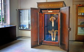 The auto icon of philosopher Jeremy Bentham at University College London (UCL). Notice how none of his preserved skin is visible, and that the head atop his shoulders is a wax replica.