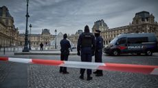 Police seal off the entrance to the Louvre following a massive heist at the museum.