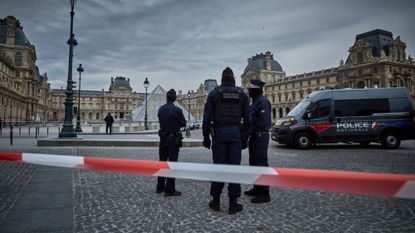 Police seal off the entrance to the Louvre following a massive heist at the museum.