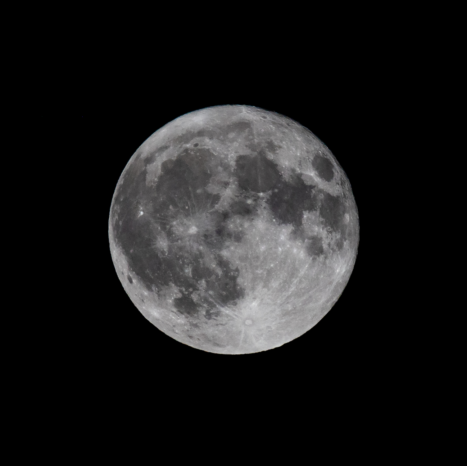 Fully lit moon on black background of night sky.