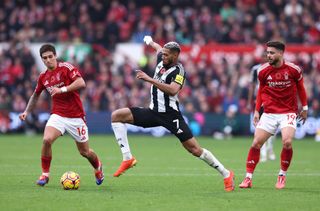 Nicolas Dominguez of Nottingham Forest battles for possession with Joelinton of Newcastle United during the Premier League match between Nottingham Forest FC and Newcastle United FC at City Ground on November 10, 2024 in Nottingham, England.