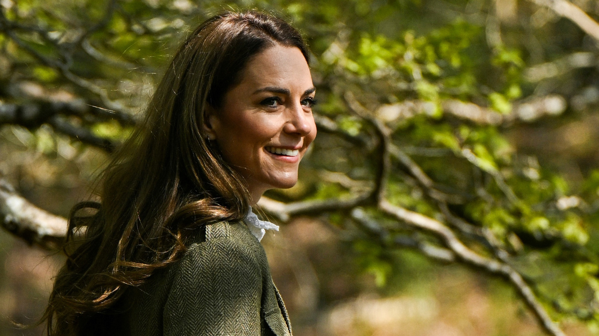 Kate Middleton seen in the countryside posing in the glowing sun while wearing a tweed jacket and a white shirt