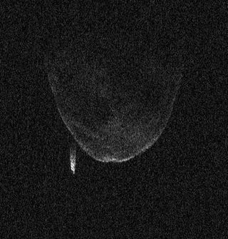 Radar image of asteroid 1998 QE2 and its moon taken on June 7, 2013, by the Arecibo Observatory. Several craters are visible on the asteroid, and the moon appears as a bright streak. Each pixel is 7.5 meters (25 feet) across.