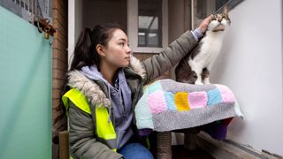 Rescue volunteer petting a cat