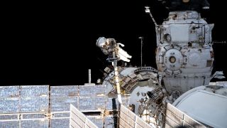 Roscosmos cosmonaut Pyotr Dubrov performs a spacewalk in June 2021 at the International Space Station. The Russian Zvezda module appears below him in the picture. To the right is the old Russian Pirs docking port, which was removed to make way for the updated Nauka science and docking module in July 2021.