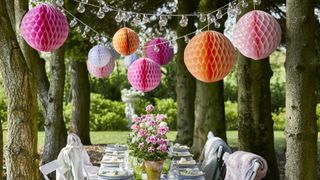Garden party table with pom poms and honeycones