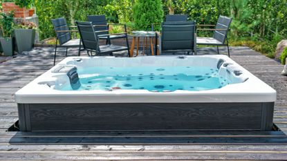 A large hot tub on a backyard terrace