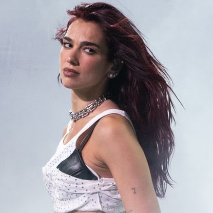 Dua Lipa wearing a white t shirt as a skirt at Glastonbury