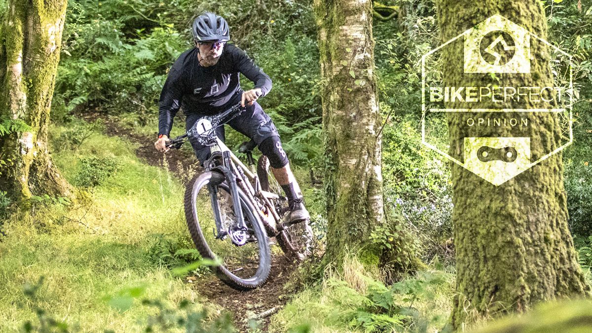 A mountain biker rides through some muddy ruts