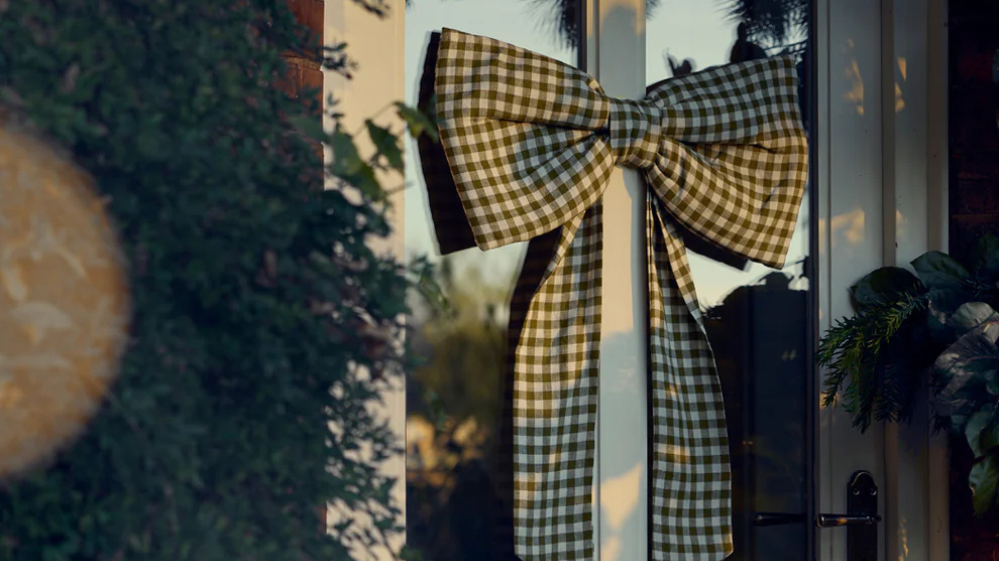 a gingham bow on a front door