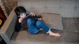 A child watching TV on a tablet