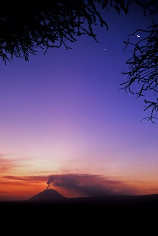 The awe and beauty of awaking in a Tanzanian tent camp to a stunning sunrise, a volcano eruption and a tight configuration of Venus, Jupiter and the Moon explains the Masai name for the volcano, "Mountain of God."