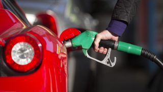 Gas prices are soaring in the U.K. Here, an image of a closeup of someone pumping gas into their car.