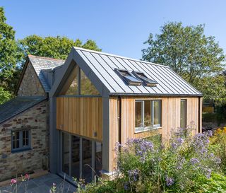 the house cladding on this extension to a barn conversion is timber and zinc